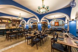 a restaurant with blue walls and tables and chairs at Pi’s Boutique Sapa in Sapa
