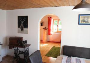 a living room with a table and an archway at Ferienwohnung Brustmann in Teisendorf