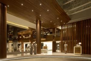 a lobby with a man standing in the middle of a building at Double - Six, Luxury Hotel - Seminyak in Seminyak