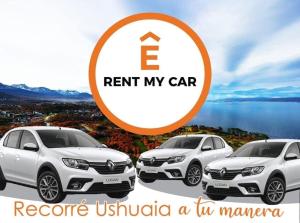 a picture of three cars parked next to a lake at El Refugio Lodge Hostel in Ushuaia