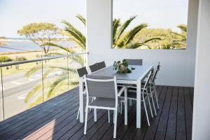 a table and chairs on a balcony with a view of the ocean at Great Ocean Road Resort in Anglesea