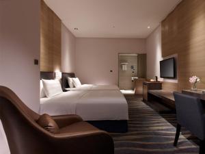 Postel nebo postele na pokoji v ubytování City Suites - Kaohsiung Chenai