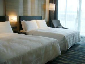 Postel nebo postele na pokoji v ubytování City Suites - Kaohsiung Chenai