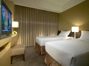 A bed or beds in a room at City Suites - Taoyuan Gateway