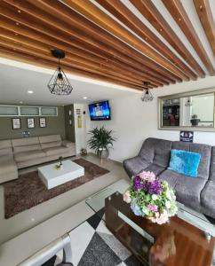 a living room with a couch and a table at Hotel Suramericana in Medellín