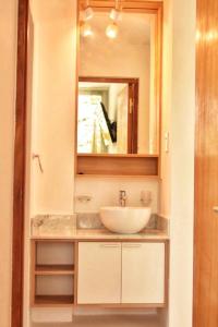 a bathroom with a sink and a mirror at Ayres de Nieva 2 in San Salvador de Jujuy