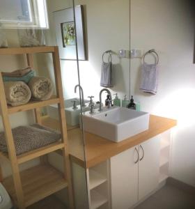 a bathroom with a sink and a mirror at The Source, Otways in Tanybryn