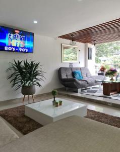 a living room with a couch and a table at Hotel Suramericana in Medellín