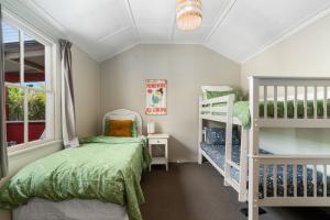 a bedroom with two bunk beds and a window at Cromwell Cutie - Cromwell Holiday Home in Cromwell