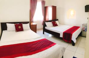 Postel nebo postele na pokoji v ubytování Đức Trọng Hotel