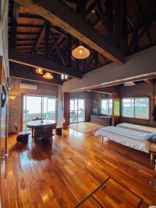 a large room with a bed and a pool table at PANORAMA Ocean View Cottage in Motobu