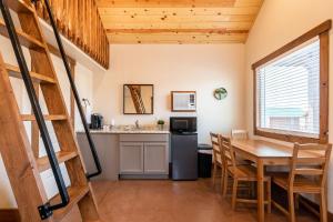 a kitchen and dining room with a table and chairs at Gooseberry Lodges Zion National Park Area in Apple Valley