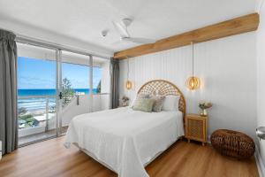 a bedroom with a bed with a view of the ocean at Baronnet Apartments in Gold Coast +174 photos