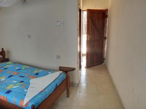 a bedroom with a bed and an open door at Triple Eden Resort - Naivasha in Naivasha +110 photos