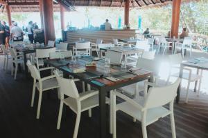 
a room with tables and chairs and a laptop at Sumilon Bluewater Island Resort in Sumilon Island
