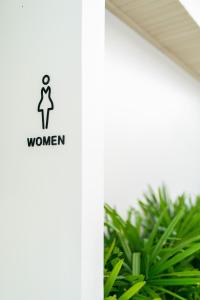 a bathroom with a sign that reads women at Panwaburi Beachfront Resort - SHA Extra Plus in Panwa Beach