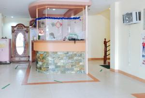 a kitchen with a stone fireplace in a living room at RedDoorz @ Eros Travellers Pensione in Iloilo City