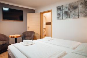 Pokój hotelowy z 2 łóżkami i krzesłem w obiekcie Panorama View w mieście Öblarn