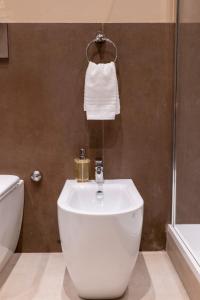 a bathroom with a toilet and a sink and a shower at Domus Aurelia in Rome