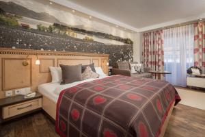 a bedroom with a large bed in a room at Hotel Sommer Füssen in Füssen +84 photos