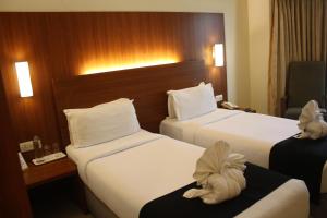 Postel nebo postele na pokoji v ubytování Orbett Hotel