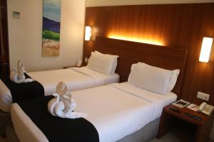 Postel nebo postele na pokoji v ubytování Orbett Hotel