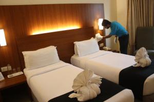 Postel nebo postele na pokoji v ubytování Orbett Hotel