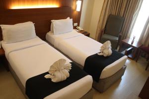 Postel nebo postele na pokoji v ubytování Orbett Hotel