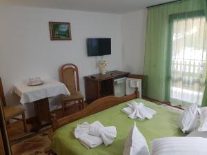 a room with two beds with towels on them at Grandemi Belvedere Bucovina in Frasin +140 photos