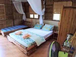 a bedroom with two beds in a room at Mekong Delta Ricefield Lodge in Can Tho +93 photos