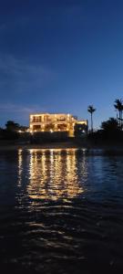 a house on the shore of a body of water at night at Beachfront Bed & Breakfast in San Jose