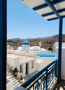 a view from a balcony of a white building with a mosque at fanis sweet home in Kampos Paros