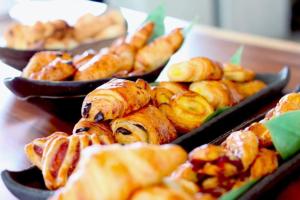 a table topped with trays of pastries and other pastries at Travelodge in Gaborone