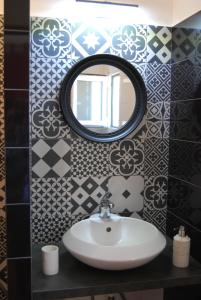 a bathroom with a sink and a mirror at Spiti Anatoli in Karfas
