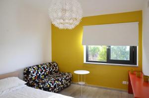 a bedroom with a bed and a chair and a window at La Casa del Riccio in Tindari