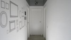a hallway with pictures on the walls of a room at La Casa del Riccio in Tindari
