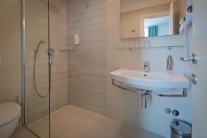 a bathroom with a sink and a shower at Hotel Bor in Krk