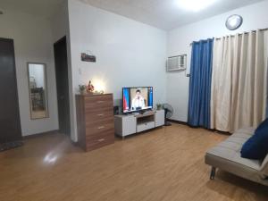 a living room with a tv and a couch at Room in Studio - Mesaverte Residences Afs Suites in Cagayan de Oro