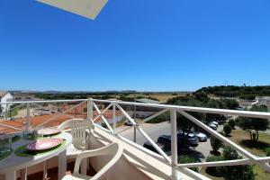 a balcony with a table and a view of a parking lot at Falesia Beach Apartment in Albufeira