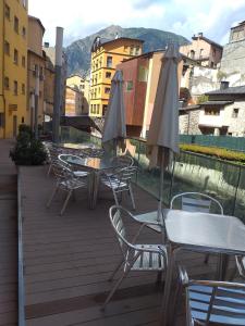 a patio area with tables and chairs and umbrellas at Siracusa in Andorra la Vella