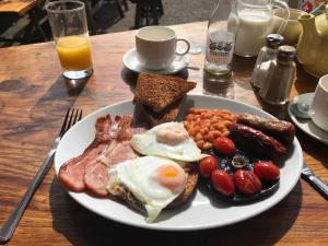 a plate of breakfast food with eggs sausage beans and toast at Rose and Crown at Redmarley in Redmarley DʼAbitot