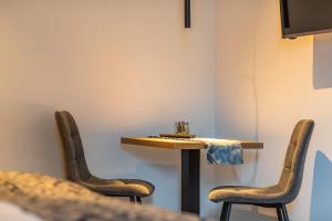 a table in a room with two chairs and a table at Lichti´s Rooms & Appartements in Aspang Markt