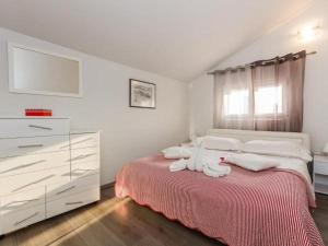 a bedroom with a bed with towels on it at Apartments Roda in Supetar