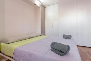 a bedroom with a large bed with two pillows on it at Leonardo in Cagliari