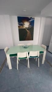 ein grüner Tisch und zwei Stühle in einem Zimmer in der Unterkunft Apartamento Islas Malvinas 39 in Vecindario