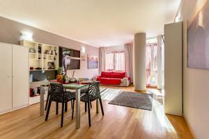 a kitchen and living room with a table and chairs at Leonardo in Cagliari