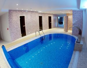 a large swimming pool in a hotel room at Aismares Hostel in Klaipėda
