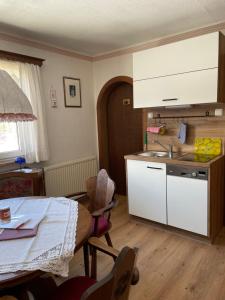 a kitchen with a table and a sink and a counter at Ferienwohnung Sonnschein in Bad Mitterndorf