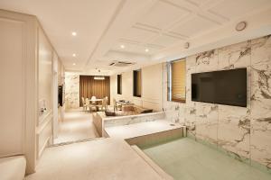 仁川市Hotel Wanted的客厅里墙上有一台电视