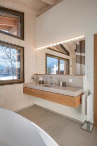 a bathroom with a sink and a mirror at Chalet Dreitorspitz - Riverside in Garmisch-Partenkirchen